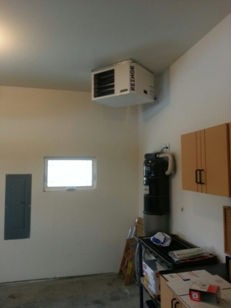 A Reznor garage heater installed on the wall of a garage by Custom Climates in Iowa City, IA.