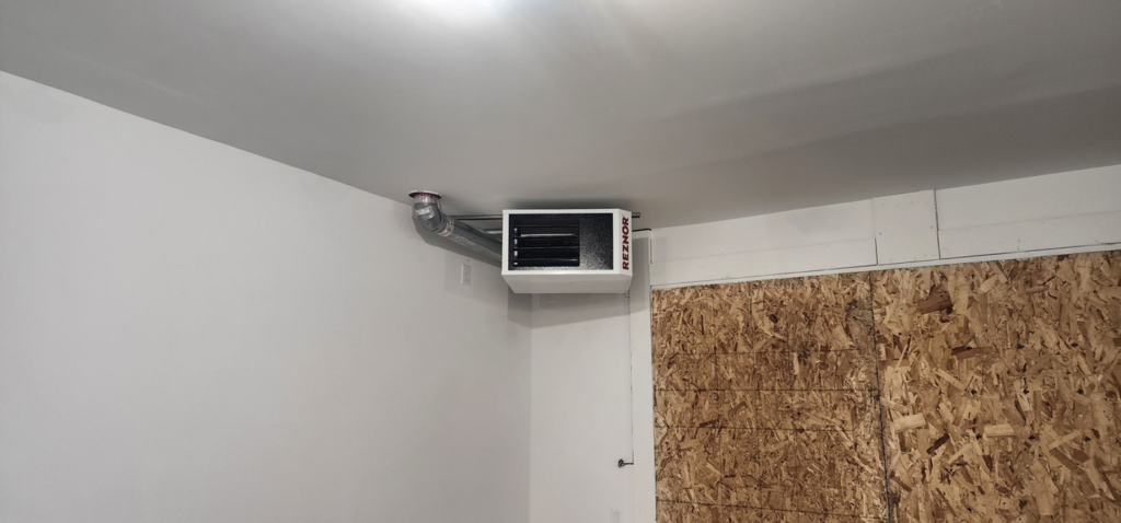 A Reznor unit heater installed on a ceiling with ductwork by Jv Services inc. in Pinellas Park, FL.