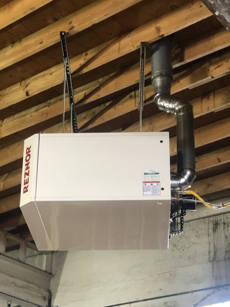 A Reznor unit heater suspended from a ceiling, professionally installed by Ohio City Heating and Cooling in Cleveland, OH.