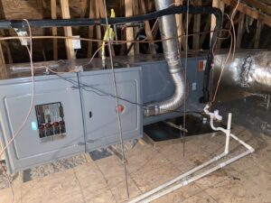 A Rheem air handler unit installed in an attic with ductwork by Kings of AC, LLC in Queen Creek, AZ.