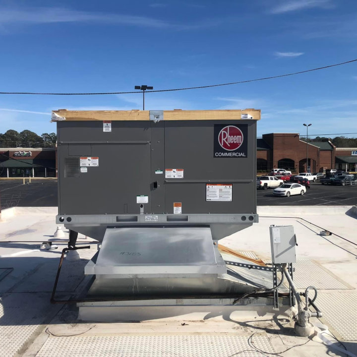A large Rheem commercial HVAC unit installed on a flat rooftop, serviced by Eleven Heating and Cooling in Birmingham, AL.