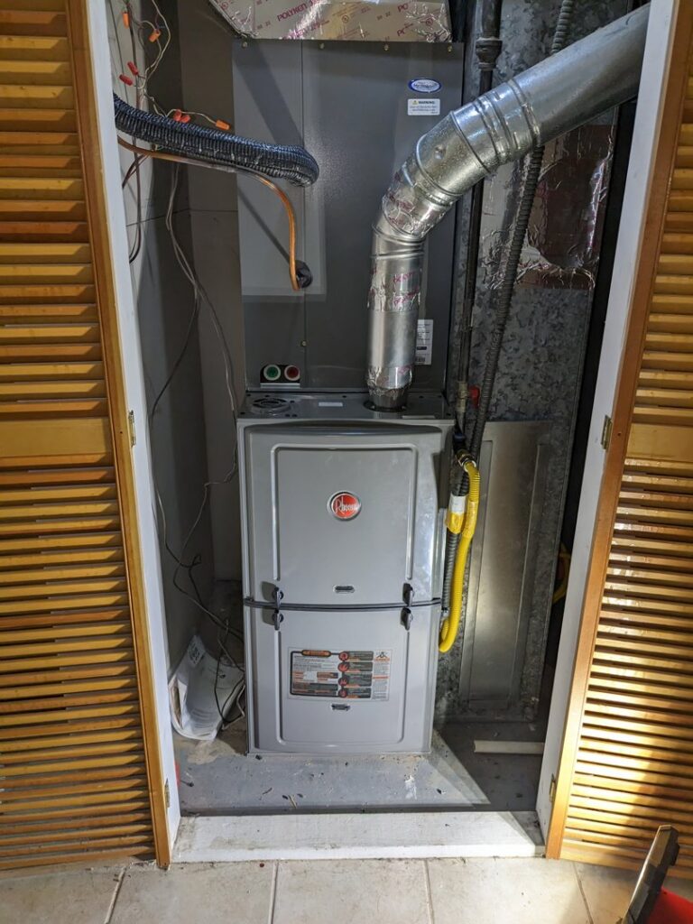 A Rheem furnace and air handler unit installed in a utility closet by Inspector Rogers LLC in Draper, UT.