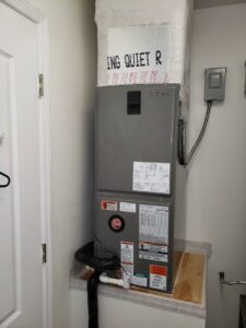A Rheem furnace or air handler unit with ductwork installed indoors by JM HVAC Pros in Elgin, IL.