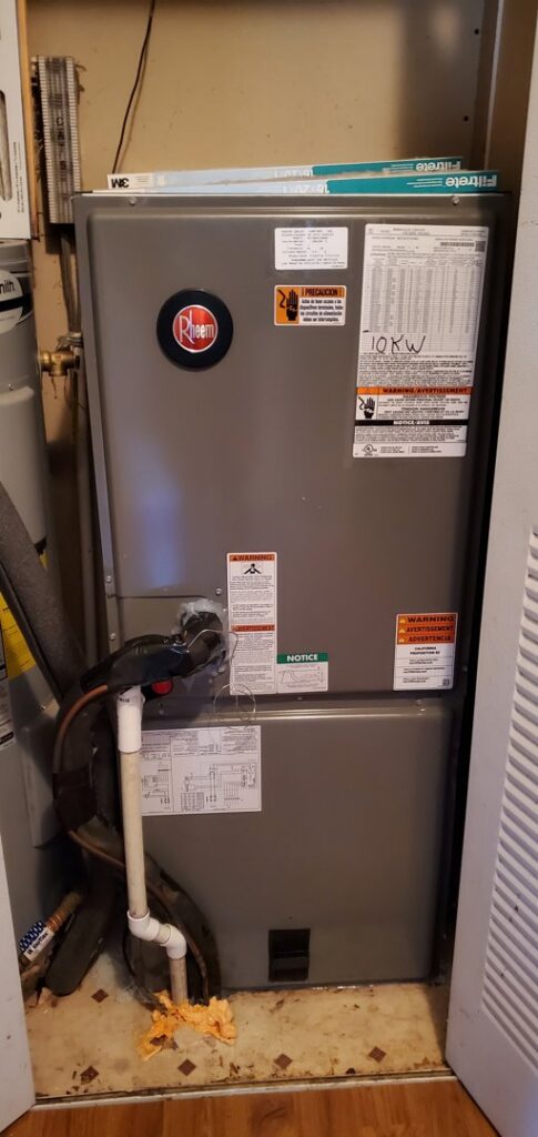 A Rheem furnace or air handler unit installed in a utility closet by MTZ Heating and Air Conditioning in Charlotte, NC.