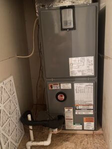 An indoor Rheem furnace and air handler unit with a clean filter nearby from Air Fix in Fayetteville, AR.