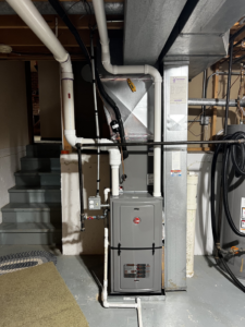 A Rheem furnace and ductwork installed in a basement by Kai's Heat & Cool in Naperville, IL