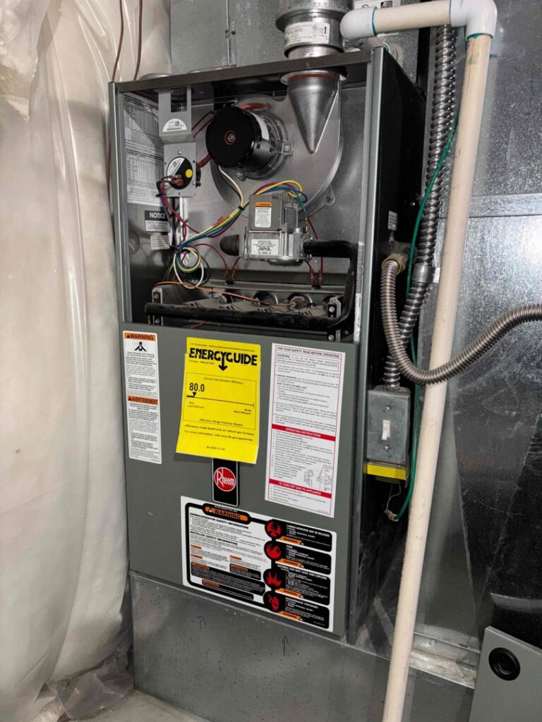 A Rheem furnace unit with an EnergyGuide label, installed by Authority Heating & Cooling in Orem, UT.