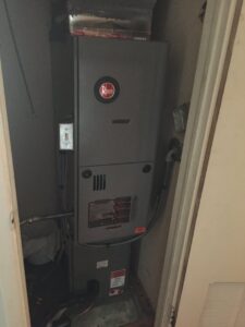 A Rheem furnace unit installed in a utility closet by ICare Heating & Air in Millcreek, UT.