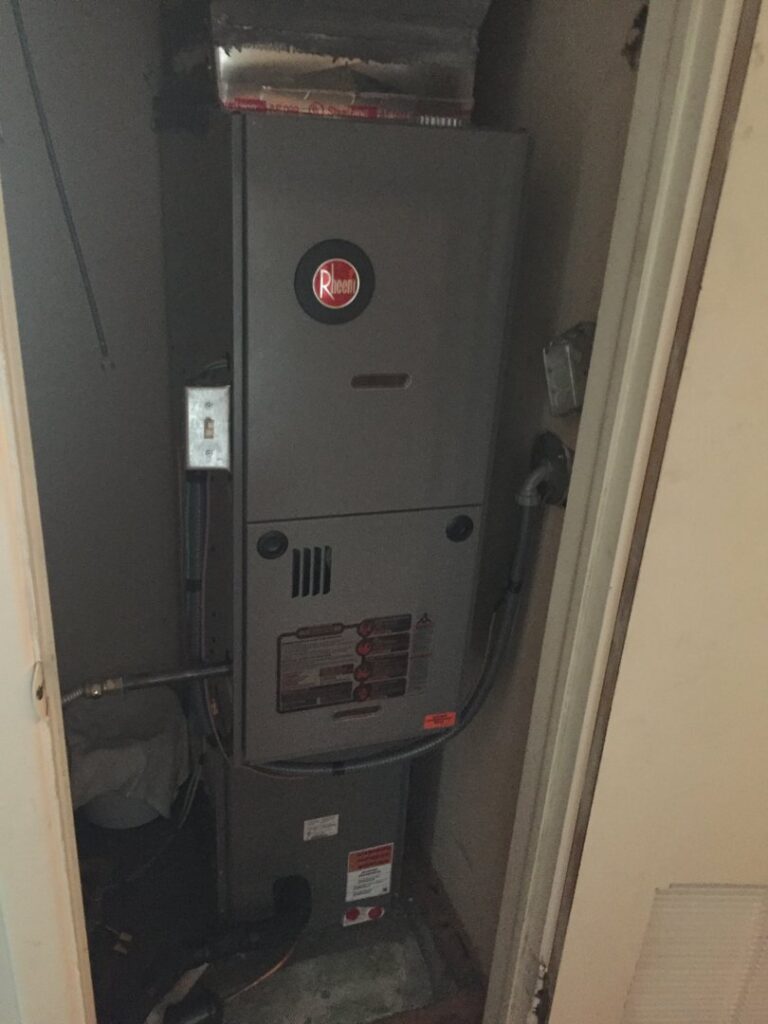 A Rheem furnace unit installed in a utility closet by ICare Heating & Air in Millcreek, UT.