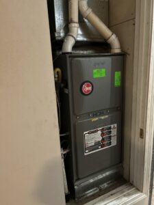 A Rheem furnace and air handler unit installed in a utility closet by Desert Sage Heating and Cooling in Albuquerque, NM.