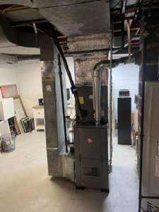 An indoor Rheem furnace unit with new ductwork installed by VHL Services LLC in Elizabeth, NJ.