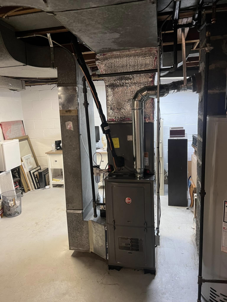 An indoor Rheem furnace unit with new ductwork installed by VHL Services LLC in Elizabeth, NJ.