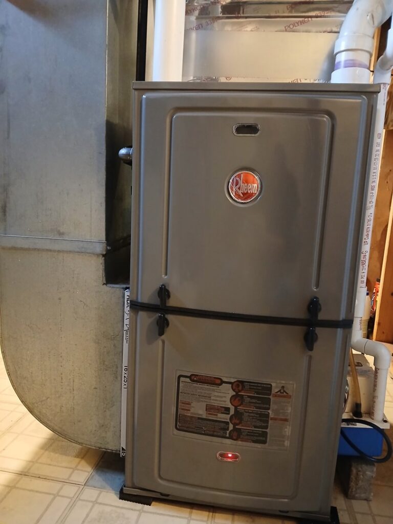 A Rheem brand furnace unit with connected ductwork, installed by Lyons Heating and Cooling in Lyons, OR.