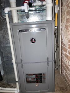 A Rheem gas furnace unit installed in a utility space by Comfy Cave Heating and Air Conditioning in Arvada, CO.