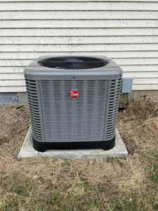 An outdoor Rheem HVAC condenser unit professionally installed by Brandon Hvac Services in Greenville, MS.