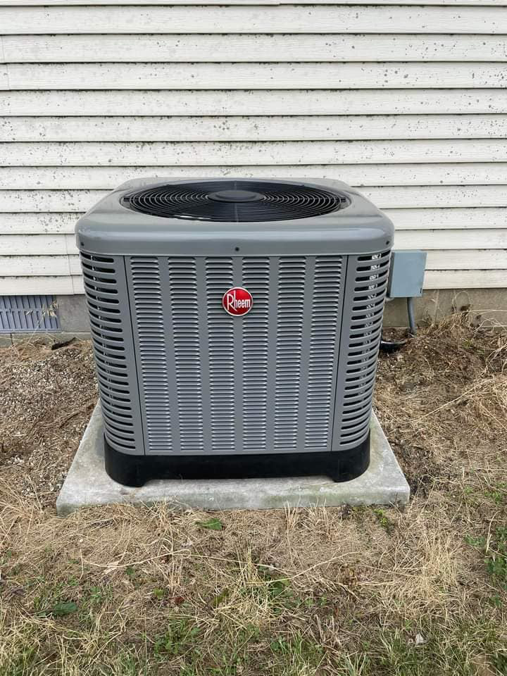 An outdoor Rheem HVAC condenser unit professionally installed by Brandon Hvac Services in Greenville, MS.