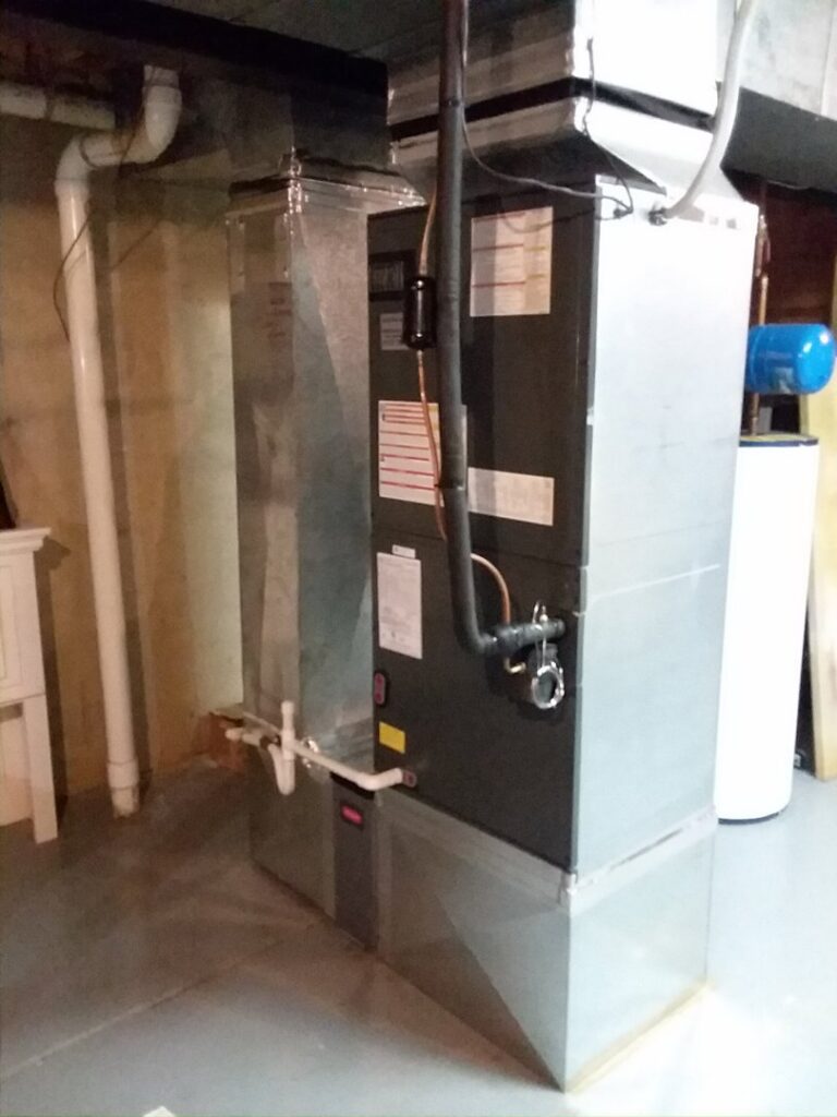A Rheem HVAC furnace and air handler unit with ductwork installed in a basement by Appliance Doctor, Inc. in Annapolis, MD.