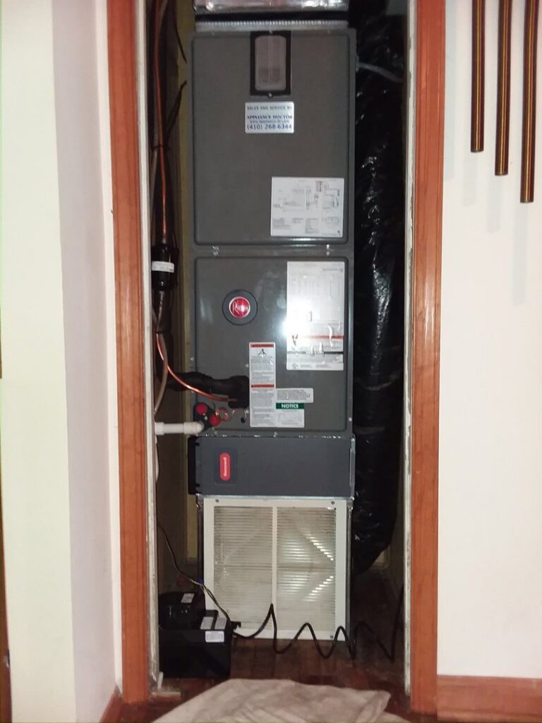 A Rheem HVAC furnace and air handler unit professionally installed in a residential closet by Appliance Doctor, Inc. in Annapolis, MD.