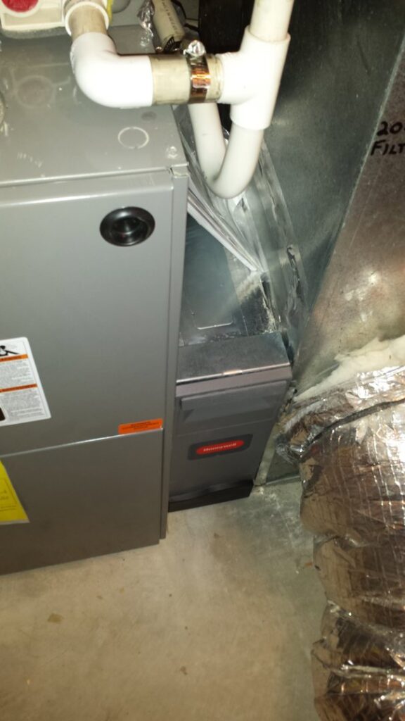A Rheem HVAC furnace and air handler unit with an attached air purification system installed by Appliance Doctor, Inc. in Annapolis, MD.