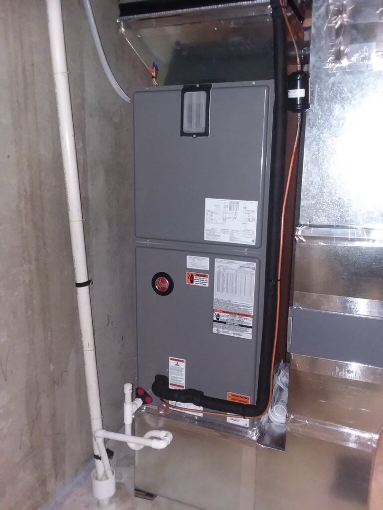 A Rheem indoor HVAC furnace and air handler unit with ductwork installed by Appliance Doctor, Inc. in Annapolis, MD.