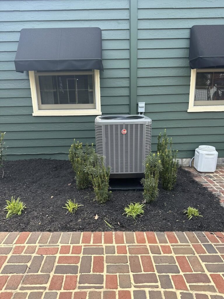 A Rheem outdoor AC unit installed next to a building, showcasing work by Trusted HVAC in Martinsburg, WV
