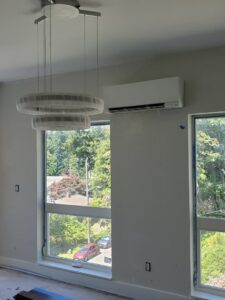 A Rheem outdoor AC unit installed by Dynamic Utility Services, Inc. Heating, A/C & Refrigeration in Shoreline, WA.