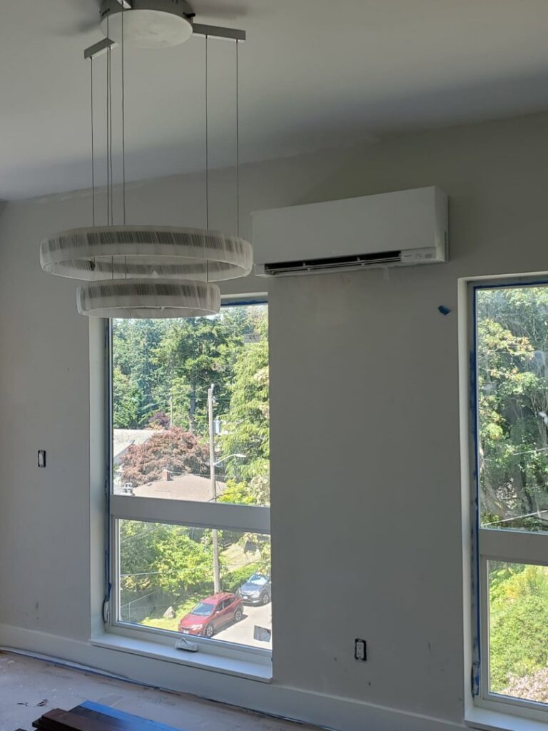 A Rheem outdoor AC unit installed by Dynamic Utility Services, Inc. Heating, A/C & Refrigeration in Shoreline, WA.