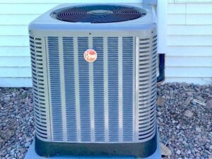 A Rheem outdoor air conditioning unit installed by QC Mechanical, Inc. in Lockport, NY.