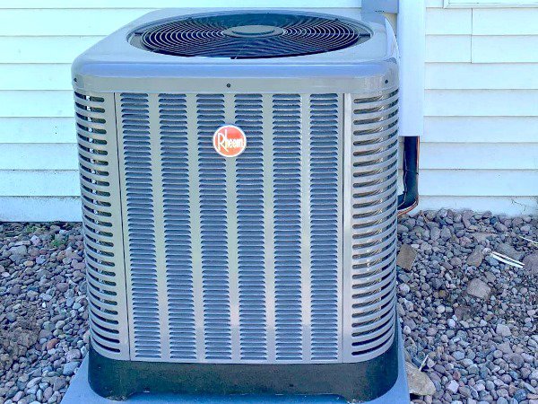 A Rheem outdoor air conditioning unit installed by QC Mechanical, Inc. in Lockport, NY.
