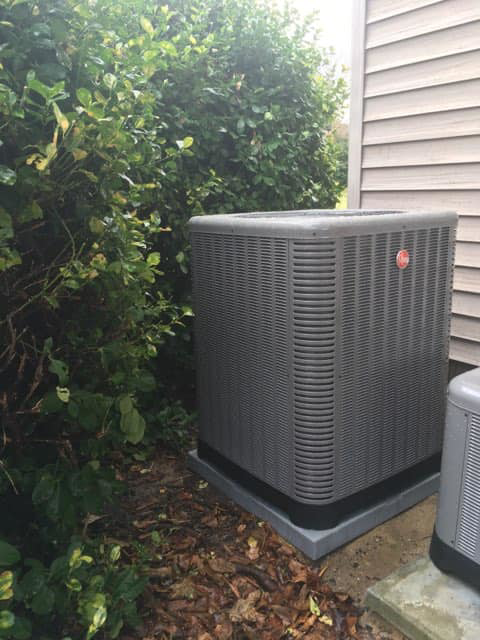 A Rheem outdoor HVAC unit installation next to a house, completed by James HVAC LLC in Georgetown, DE.