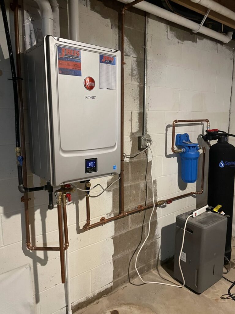 A newly installed Rheem tankless water heater and water filtration system by Jbus Pipe, Plumbing, Heating & Air in Parkersburg, WV.