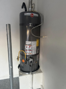 A newly installed Rheem water heater, showing professional plumbing and venting work by CaliFam Services in Las Vegas, NV.