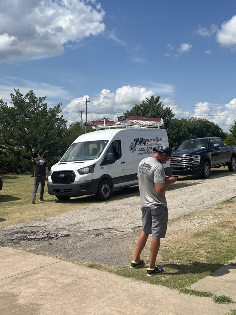 Rhino Heating and Air Conditioning LLC service vans and technicians on a job site, ready to provide HVAC services in Norman, OK.