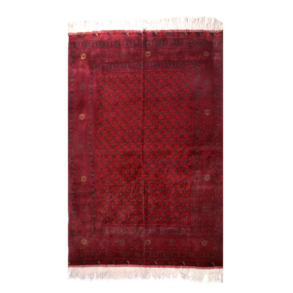 A rich red traditional carpet with subtle patterns displayed by Mawr Store, a carpet contractor in Chaman-e-Hozori, Kabul, AF