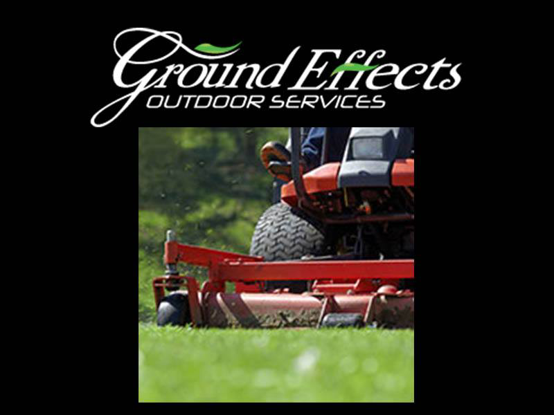 A riding lawn mower actively cutting grass, demonstrating professional lawn care by Ground Effects Lawn Care in St. Louis, MO.