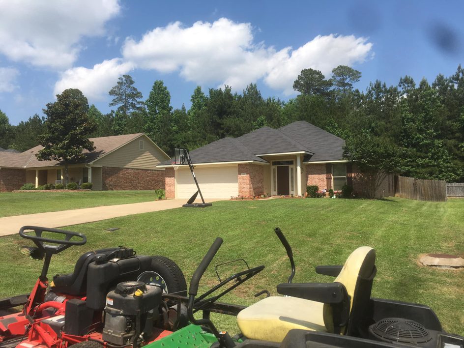 Two riding lawn mowers on a residential property, ready for or after a lawn care service by Taylor Cutts lawn Care Service llc in Shreveport, LA