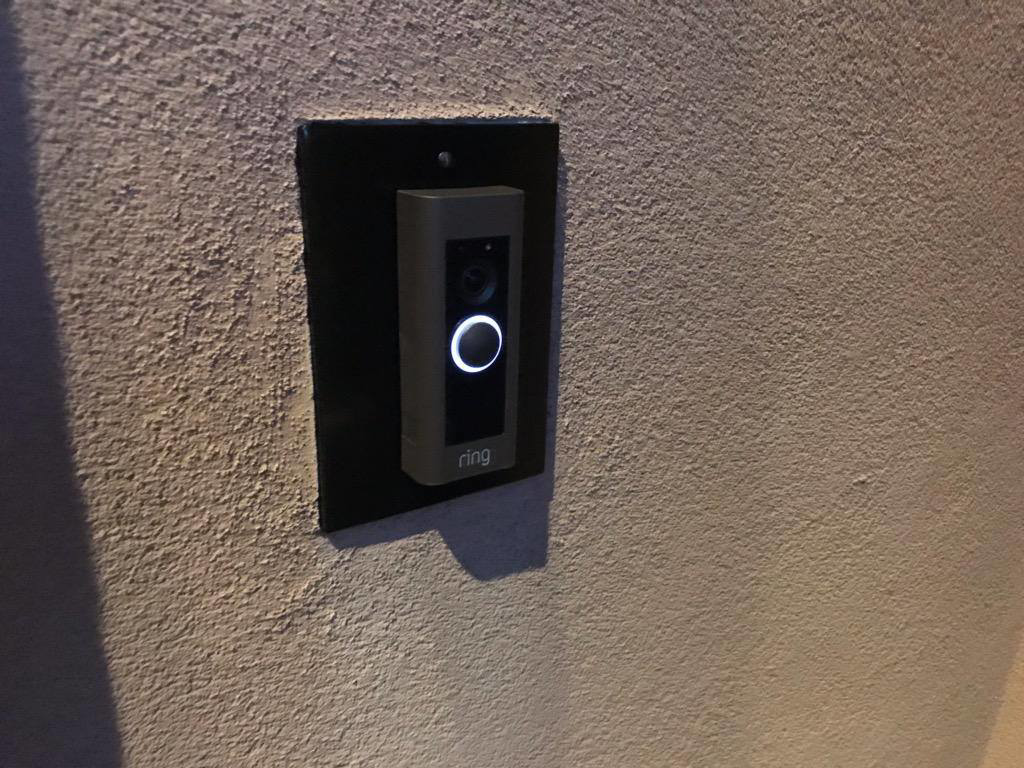 A Ring smart doorbell professionally installed on a textured wall by Lundell Electrical Services in Mesa, AZ.