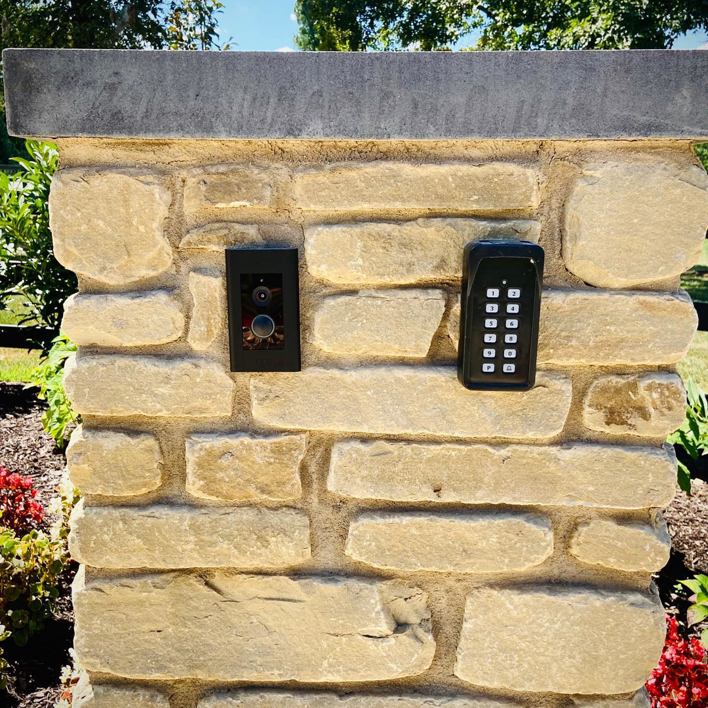 A Ring doorbell and keypad entry system installed on a stone pillar by Natural State Electric LLC in Fayetteville, AR.