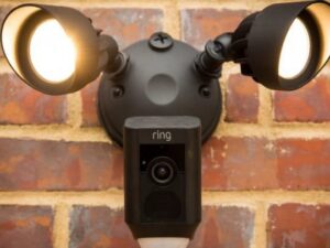 A Ring floodlight camera professionally installed on a brick wall by Decatur Electrician Now in Decatur, AL.