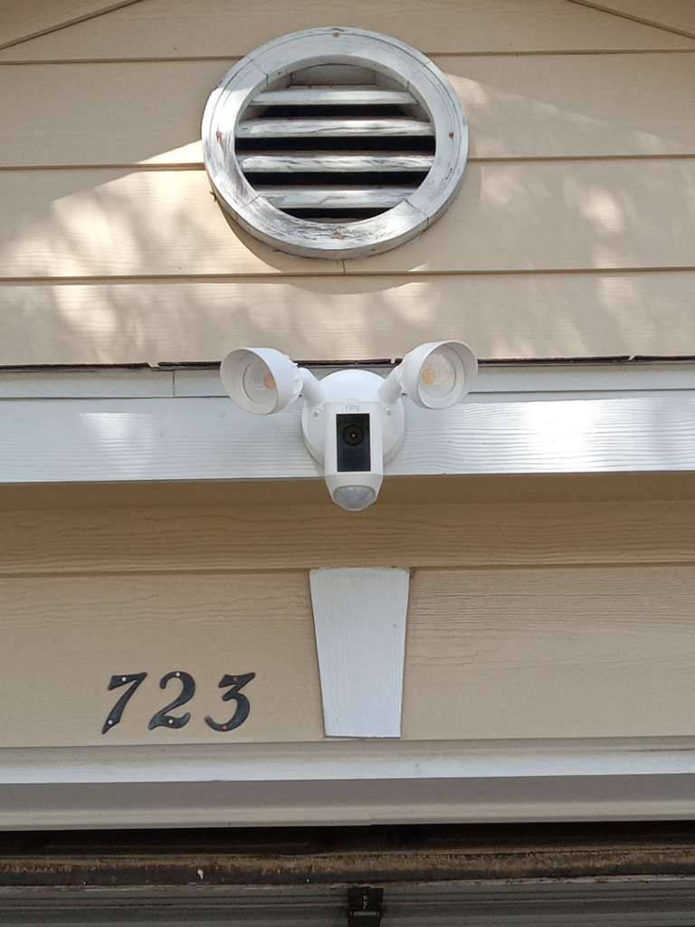 A Ring Floodlight Camera installed on the exterior of a home by Valle Home Maintenance in Houston, TX