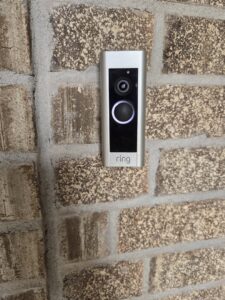 A Ring video doorbell installed on a brick wall by ABS Electrical Services in Rogers, AR.