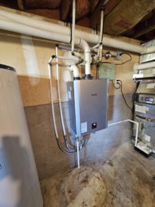A Rinnai tankless water heater installation by Alpine Heating in a utility area in Eugene, OR.