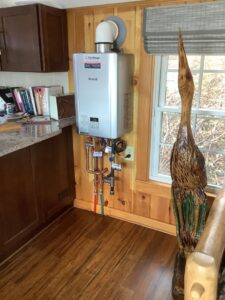 A Rinnai tankless water heater installed on a wall by Heritage Home Service in Worcester, MA
