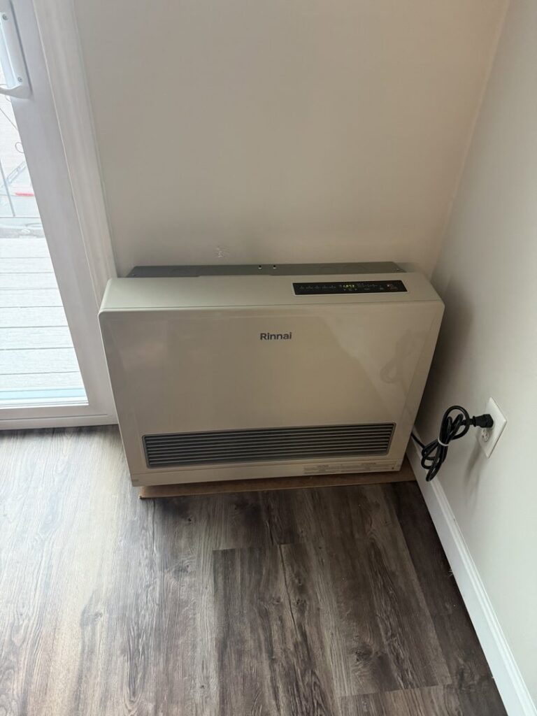 A Rinnai wall-mounted heating unit installed indoors by Revolution HVAC in Owings Mills, MD.