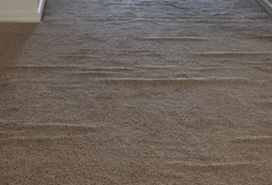 A rippled carpet needing stretching service before repair by The Carpet Medic in Suffolk, VA