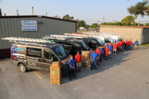 The R.J. Nelson Co HVAC team standing with their service vans and new equipment in Council Bluffs, IA.