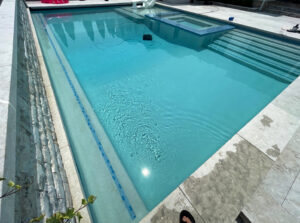 A robotic pool cleaner maintaining a sparkling clean pool for Aqua Doc Pool And Spa in Franklin, TN.