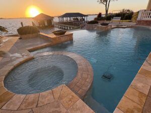 A robotic pool cleaner actively cleaning a residential pool by Gayle Force Pools in Lake Charles, LA
