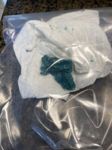 Blue rodent bait on a paper towel, used for rodent control by A-TEX PEST MANAGEMENT INC. in Austin, TX