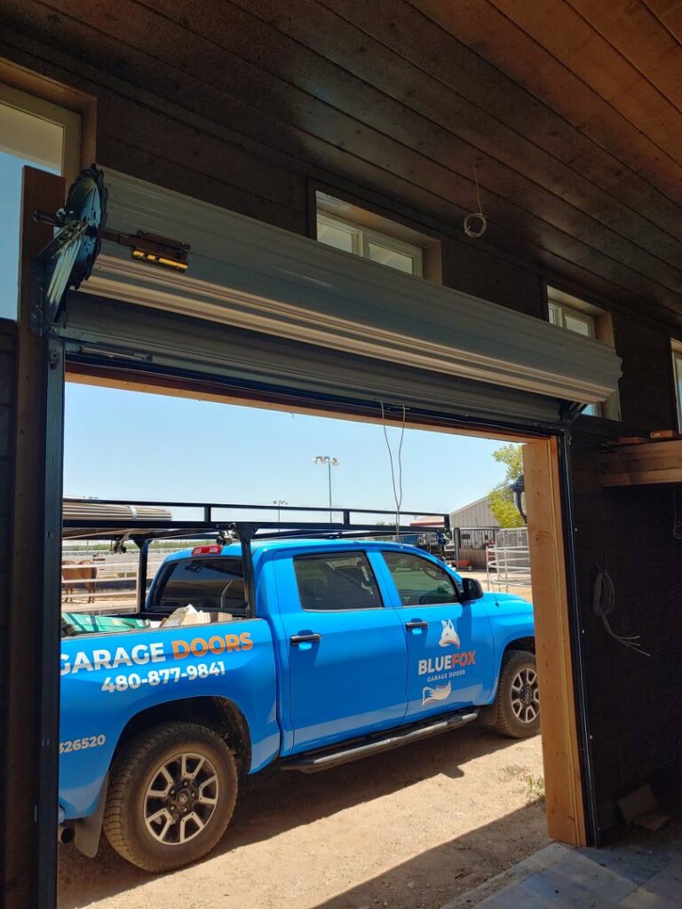 A roll-up garage door being installed in a barn-like structure by Blue Fox Garage Doors in Gilbert, AZ.